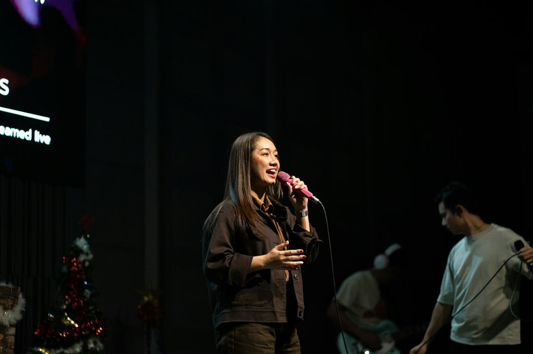 woman speaking on stage confidently